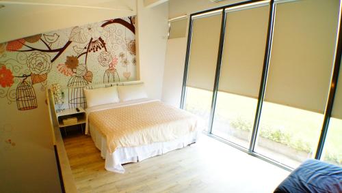 Postel nebo postele na pokoji v ubytování Lan Yang Resort Four Seasons