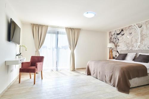 a bedroom with a bed and a desk and a chair at Villa Dolcea in Umag