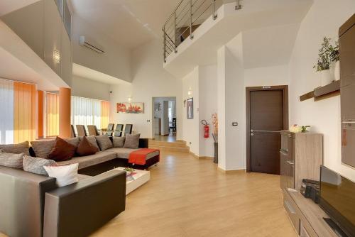 a living room with a couch and a tv at Villa Marcelia in Pula