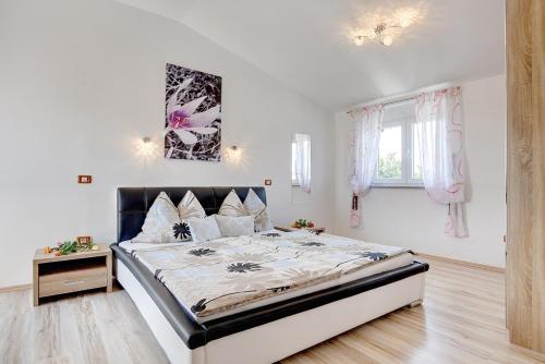 a white bedroom with a large bed in it at Villa Marcelia in Pula