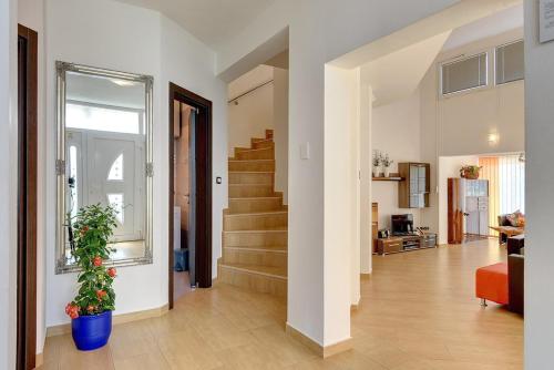 a living room with a stair case and a hallway at Villa Marcelia in Pula