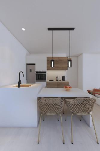 a kitchen with a table and two chairs at 3-bedroom villa Penelope in Andiparos