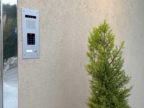 a wall with a remote control next to a tree at Private Pool House By Natchos in Virós
