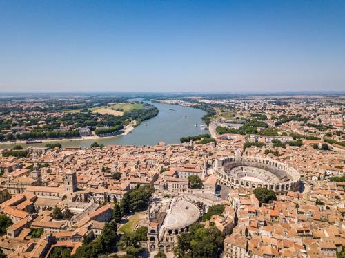 an aerial view of a city and a river at La Joliette Arles centre in Arles