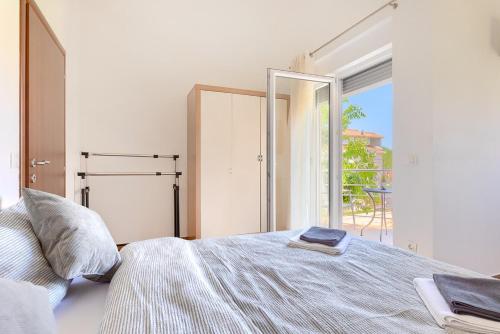 a bedroom with a bed and a large window at Villa Lara 1 in Ližnjan