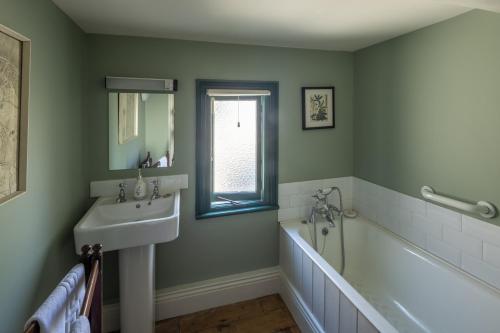 a bathroom with a sink and a bath tub at Castletown Round House in Celbridge