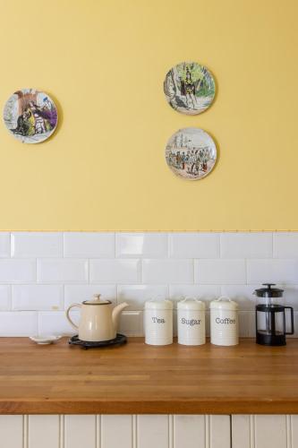 a kitchen counter with three plates on the wall at Castletown Round House in Celbridge