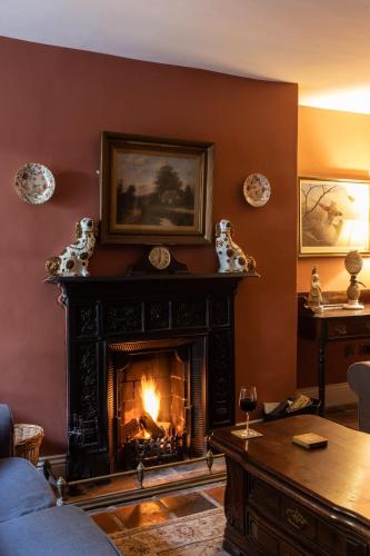 a living room with a fireplace and a couch at Castletown Round House in Celbridge