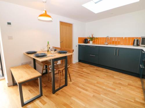 a kitchen with a table and chairs in a room at Yew Tree Cottage in Matlock