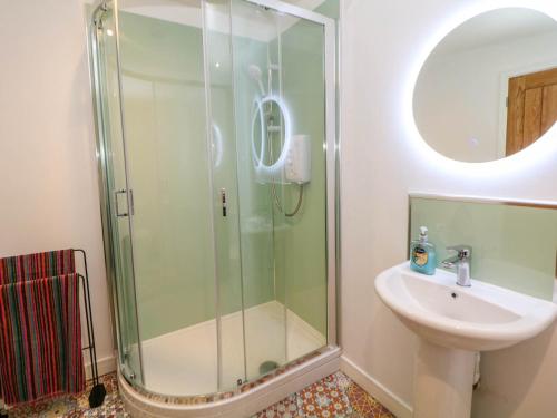 a bathroom with a shower and a sink at Yew Tree Cottage in Matlock