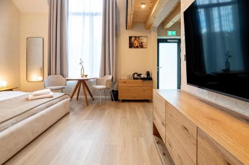a living room with a large flat screen tv at Apartmany CASA MIA in Bojnice