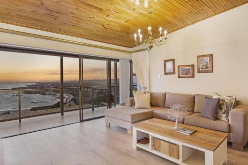 a living room with a couch and a table at Zaria Sun Penthouse by Host Agents in Cape Town