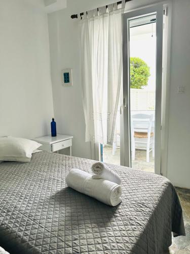 a bedroom with a bed with a towel on it at Nostos Studios in Parikia