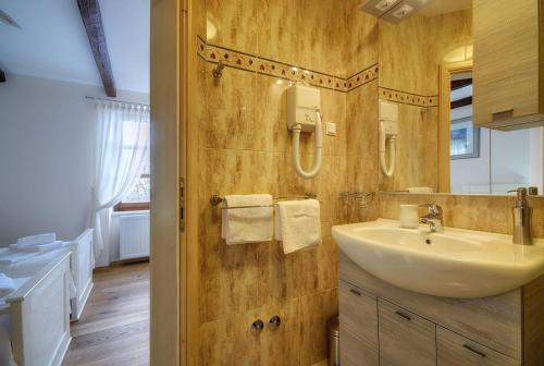a bathroom with a sink and a mirror at House Casa Silvano in Golaš
