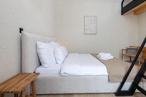 a bed with white sheets and pillows in a room at Apartmany CASA MIA in Bojnice
