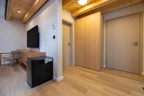 a living room with a flat screen tv and a door at Apartmany CASA MIA in Bojnice