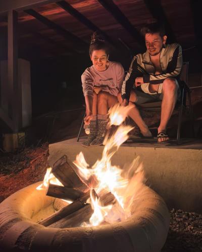 a group of three people sitting around a fire at Oasis Barichara in Barichara
