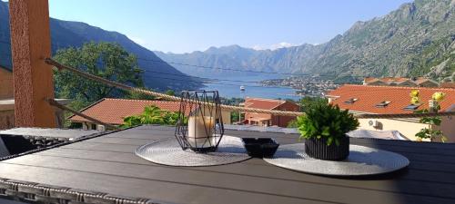 a table on a balcony with a view of a mountain at Apartman Luka in Trojica