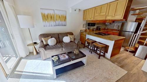 a living room with a couch and a kitchen at Crestwood 1211 Standard Studio Loft in Snowmass Village