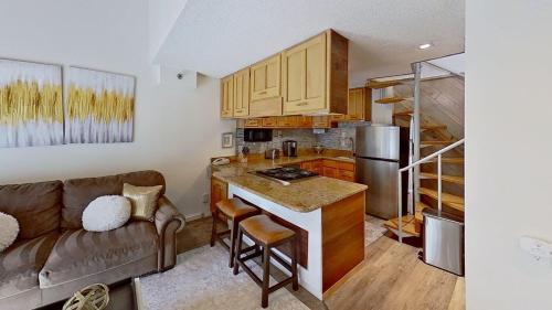 a living room with a couch and a kitchen at Crestwood 1211 Standard Studio Loft in Snowmass Village