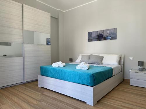 a bedroom with a bed with towels on it at Albachiara Suite Palermo close Airport in Capaci