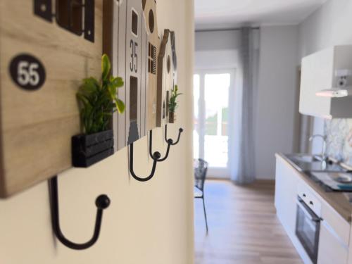 a kitchen with a refrigerator with plants on it at Albachiara Suite Palermo close Airport in Capaci