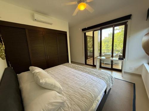a bedroom with a bed and a large window at Selva Tulum - HiveNB in Tulum