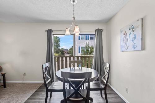 a dining room with a table and chairs and a window at Brandywine Unit 203 in Myrtle Beach