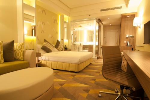 Pokój hotelowy z sypialnią z łóżkiem i biurkiem w obiekcie Hotel Benilde Maison De La Salle w mieście Manila