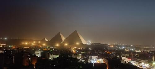a view of the pyramids of giza at night at ALADDIN PYRAMIDS View in Cairo