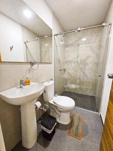 a bathroom with a toilet and a sink and a shower at Casa Playa Boquilla in Cartagena de Indias