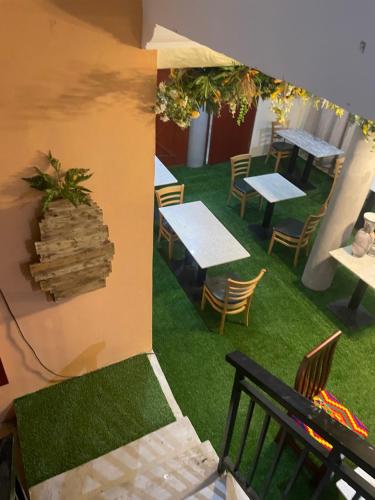 an overhead view of a patio with tables and chairs at Da palm Inn in Aburi