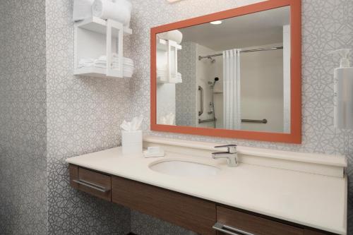 a bathroom with a sink and a mirror at Hampton Inn & Suites Yonkers - Westchester in Yonkers