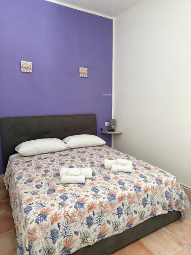 a bedroom with a bed with two towels on it at Dream House in San Giovanni Suergiu