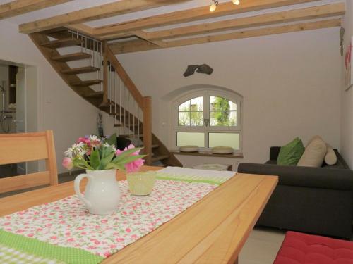 a living room with a table with a vase of flowers at Kapellenhof in Glottertal