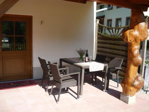 a dining table and chairs on a patio at Kapellenhof in Glottertal