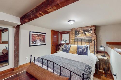 a bedroom with a bed and a brick wall at Volunteer Park Vacation in Seattle