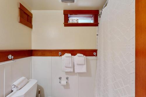 a bathroom with a toilet and a shower with towels at Volunteer Park Vacation in Seattle