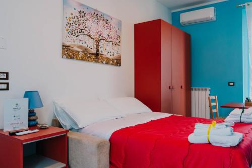 a bedroom with a red bed and a red cabinet at B&B Dimora Portanuova in Casalbordino