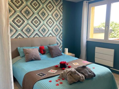 a bedroom with a bed with blue walls at "L Eden enchanté" Chambres d'hôtes et SPA privatif massages Bulle d Eden boucau Côte Basque in Boucau