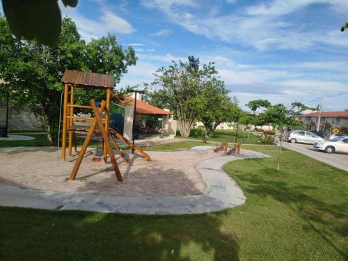 a park with a playground with a wooden swing at Charmoso AP VOG VILLE Caruaru in Caruaru