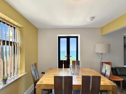 a dining room with a wooden table and chairs at Granada Apartments Berkeley in Blackpool