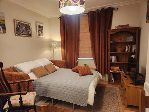 a bedroom with a bed and a book shelf at Historic Gloucester Stay - A Hidden Gem in Gloucester