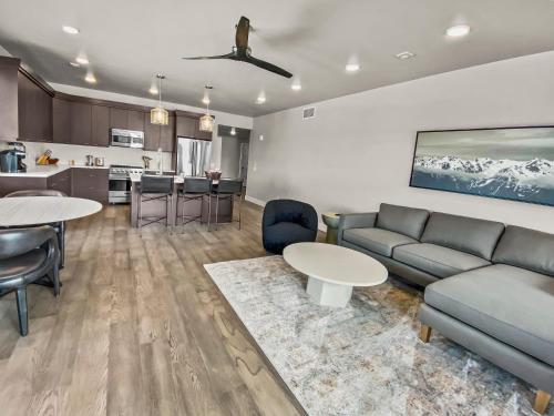 a living room with a couch and a table at 204 Jordanelle Mountain Paradise by SkyRun Park City in Heber City