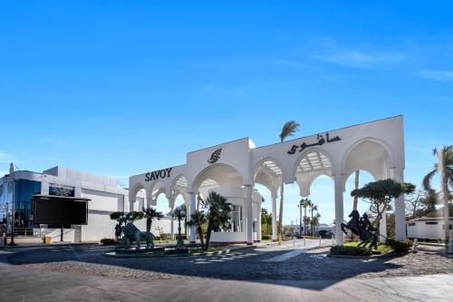 a building with arches and statues in front of it at Savoy Sharm El Sheikh in Sharm El Sheikh