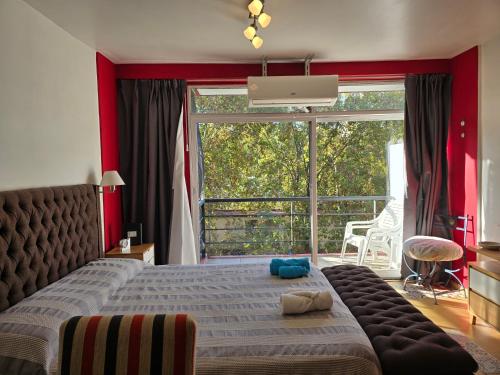 a bedroom with a bed and a large window at Luz Urbana BA Studio in Buenos Aires