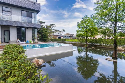 a house with a swimming pool next to a house at Island Sunrise in Dongshan