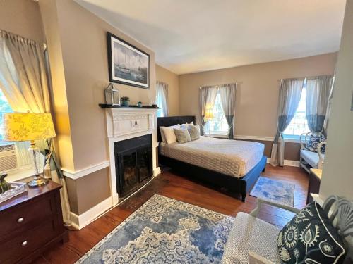 a bedroom with a bed and a fireplace at Old Brick Inn in Saint Michaels