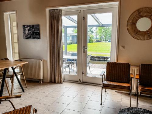 a living room with a sliding glass door at De Sloothaak in Giethoorn