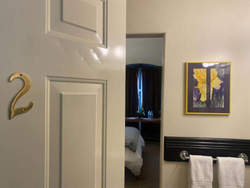 a bathroom with a door with a mirror and a bedroom at The Signature King with Mountain Views in Bisbee